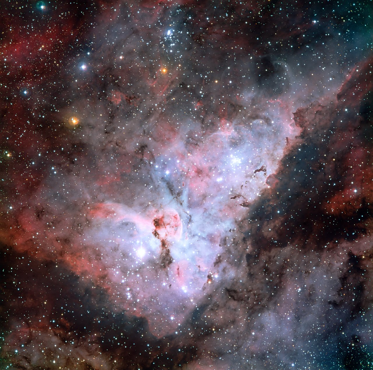 Colour-composite image of the Carina Nebula, revealing exquisite details in the stars and dust of the region. Several well known astronomical objects can be seen in this wide field image : to the bottom left of the image is one of the most impressive binary stars in the Universe, Eta Carinae, with the famous Keyhole Nebula just adjacent to the star. The collection of very bright, young stars above and to the right of Eta Carinae is the open star cluster Trumpler 14. A second open star cluster, Collinder 228 is also seen in the image, just below Eta Carinae. The Carina Nebula also bears the NGC 3372 designation. On this image, North is up and East is to the left. The field of view is 0.55 x 0.55 degrees, covering a 72 x 72 light-year region at the distance of the nebula. This image is available as a mounted image in the ESOshop.